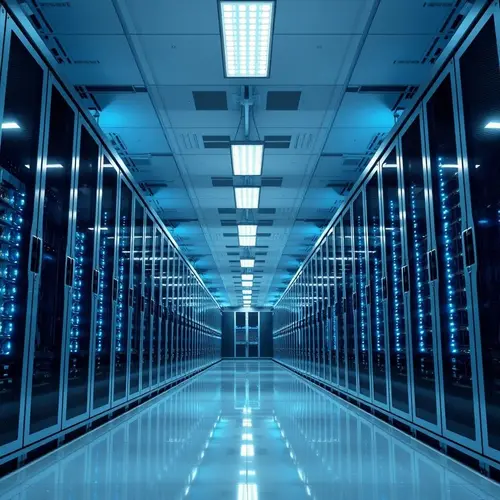Rows of server racks in a modern data center with blue and white lighting.