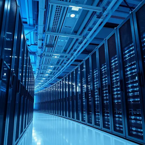 Rows of server racks in a modern data center with cool blue lighting