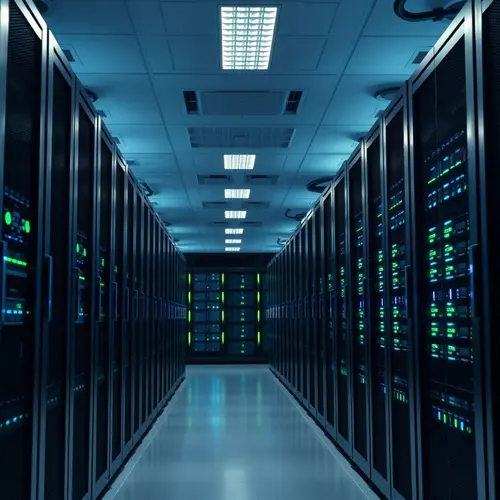 A wide view of a modern data center server room with numerous illuminated server racks.