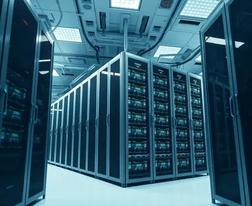 A wide shot of tall, industrial server racks in a clean, modern data center environment.