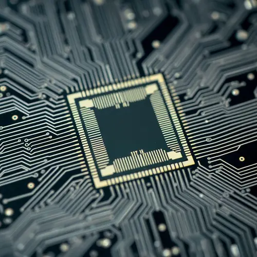 Close-up image of a silicon semiconductor wafer showing intricate circuitry.