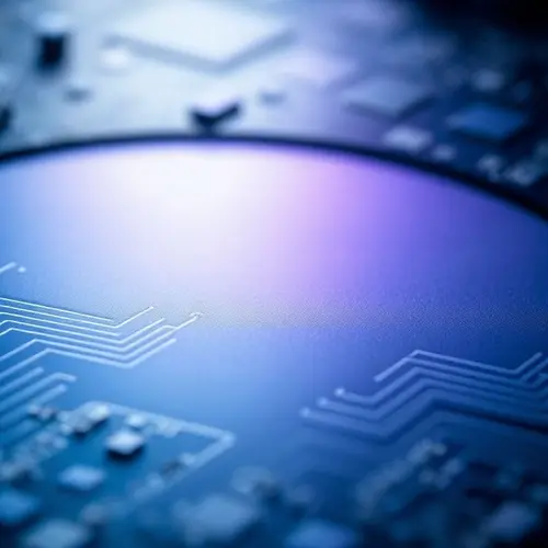 Close-up view of a silicon wafer displaying intricate microscopic circuitry.