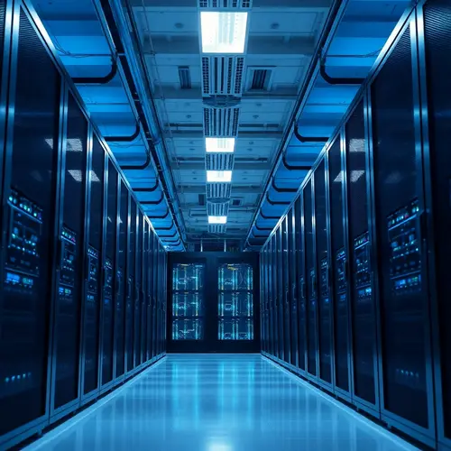 Image shows a clean, modern data center aisle with server racks and blue lighting.