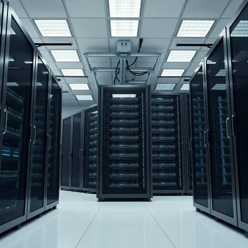 Rows of black server racks in a brightly lit, sterile data center room