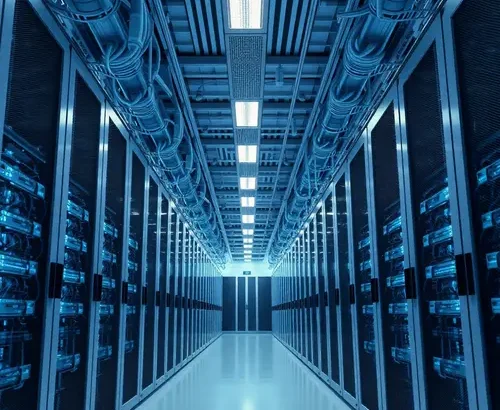 Image depicting the interior of a large data center with rows of server racks, representing digital infrastructure.