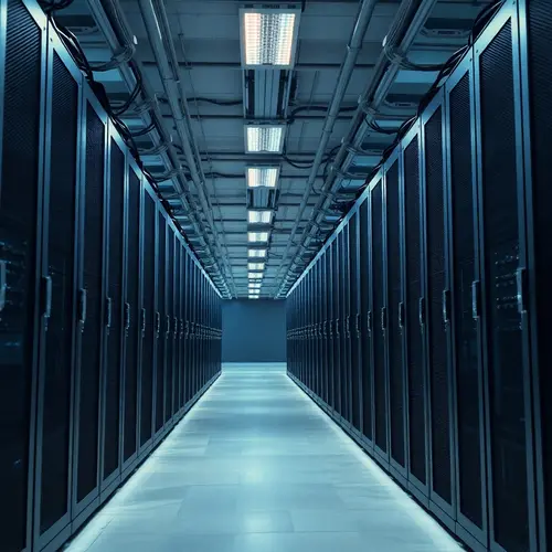 Rows of humming server racks in a modern data center with blue ambient lighting and neat cabling.