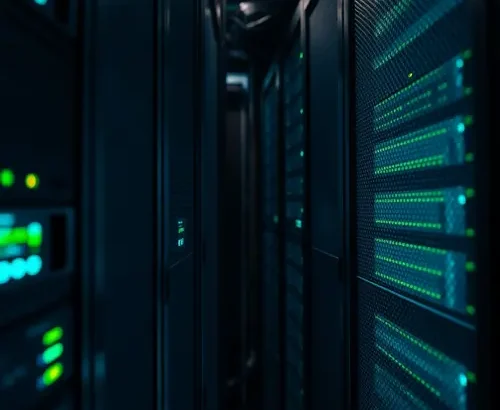 Server racks inside a modern data center with blue indicator lights, representing technological infrastructure.