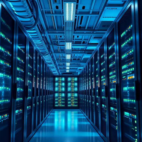 A row of server racks in a modern data center with cool blue lighting.